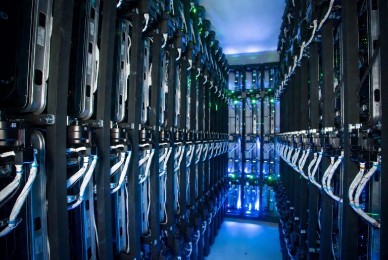 Rows of servers and network cables lit in blue.